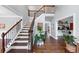 Light-filled foyer showcasing a staircase with wooden steps and a soaring two-story ceiling at 1245 Smokehouse Trl, Cumming, GA 30041