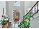 Light-filled foyer showcasing a staircase with wooden steps and a soaring two-story ceiling at 1245 Smokehouse Trl, Cumming, GA 30041