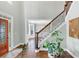 Light-filled foyer showcasing a staircase with wooden steps and a soaring two-story ceiling at 1245 Smokehouse Trl, Cumming, GA 30041