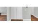 A hallway with hardwood floors and tall white cabinets at 1245 Smokehouse Trl, Cumming, GA 30041