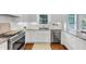 A kitchen featuring all white cabinets, stainless steel appliances, light countertops and a window at 1245 Smokehouse Trl, Cumming, GA 30041