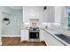 A kitchen featuring all white cabinets, stainless steel appliances, light countertops and a window at 1245 Smokehouse Trl, Cumming, GA 30041