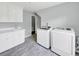 Large laundry room features modern washer and dryer units, ample storage, and stylish flooring at 1245 Smokehouse Trl, Cumming, GA 30041