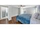 Spacious bedroom featuring hardwood floors, a ceiling fan, and an ensuite accessway at 1245 Smokehouse Trl, Cumming, GA 30041