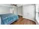 Bright bedroom boasts hardwood floors and natural light from a window and a double closet at 1245 Smokehouse Trl, Cumming, GA 30041
