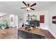 Office with hardwood floors, a large desk setup, and a view of the staircase with the front entry beyond at 1245 Smokehouse Trl, Cumming, GA 30041