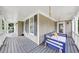 Relax on this covered porch with a swing bed, offering a serene outdoor retreat at 1245 Smokehouse Trl, Cumming, GA 30041