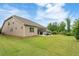 Spacious backyard with a well-maintained lawn, patio, and screened-in porch at 2965 Westlington Cir, Cumming, GA 30040