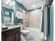 Bright bathroom featuring a shower-tub combo, granite countertop, and decorative wall art at 2965 Westlington Cir, Cumming, GA 30040