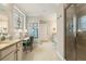 Bright bathroom with a granite vanity, decorative window, makeup desk, and tiled shower at 2965 Westlington Cir, Cumming, GA 30040