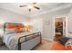 Comfortable bedroom with ceiling fan, metal bed frame, and view to brick-walled living space at 2965 Westlington Cir, Cumming, GA 30040
