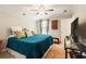 Bright bedroom featuring ceiling fan, patterned curtains, and flat-screen TV at 2965 Westlington Cir, Cumming, GA 30040