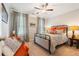 Well-lit bedroom with ceiling fan, accent pillows, and patterned curtains at 2965 Westlington Cir, Cumming, GA 30040
