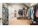 Spacious walk-in closet with organized clothing racks and shelving plus a view to the laundry room at 2965 Westlington Cir, Cumming, GA 30040