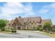Stunning clubhouse with stone accents, large windows, and well-maintained landscaping on a sunny day at 2965 Westlington Cir, Cumming, GA 30040