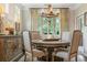 Dining room with round table, upholstered chairs, chandelier, and a decorative console table at 2965 Westlington Cir, Cumming, GA 30040