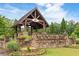 Welcoming community entrance with stone signage and manicured landscaping in a beautiful natural setting at 2965 Westlington Cir, Cumming, GA 30040