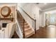 Carpeted staircase with wooden handrail and view into spacious entryway at 2965 Westlington Cir, Cumming, GA 30040