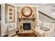 Cozy fireplace featuring a brick surround, wooden mantel, and stylish decor at 2965 Westlington Cir, Cumming, GA 30040