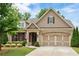 Charming home with a well-manicured lawn and a two-car garage that provides curb appeal at 2965 Westlington Cir, Cumming, GA 30040