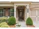 Inviting front porch of a brick home with classic columns and well-maintained landscaping at 2965 Westlington Cir, Cumming, GA 30040