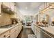 A modern kitchen features stainless steel appliances, beautiful countertops, hardwood flooring, and opens to the dining area at 2965 Westlington Cir, Cumming, GA 30040