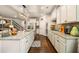 Bright kitchen features granite countertops, hardwood floors, stainless steel appliances, and a stylish center island at 2965 Westlington Cir, Cumming, GA 30040