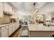 Open concept kitchen with granite countertops, stainless appliances, dark hardwood flooring, and stylish pendant lighting at 2965 Westlington Cir, Cumming, GA 30040