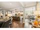 Open floor plan showcasing the kitchen, living, and dining areas, with hardwood floors and modern decor at 2965 Westlington Cir, Cumming, GA 30040