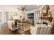 Elegant living room featuring hardwood floors, brick fireplace, and comfortable seating at 2965 Westlington Cir, Cumming, GA 30040