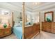 Elegant bedroom features a four-poster bed, trey ceilings, and decorative lamps at 2965 Westlington Cir, Cumming, GA 30040