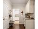 Bright mudroom featuring white cabinetry, granite counters, and view into kitchen at 2965 Westlington Cir, Cumming, GA 30040