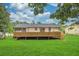 Expansive backyard featuring a large wooden deck, perfect for outdoor entertaining and relaxation at 3233 Glynn Mill Dr, Snellville, GA 30039