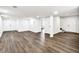 Spacious finished basement with laminate flooring, multiple doors, and access to stairs at 3233 Glynn Mill Dr, Snellville, GA 30039