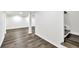 Spacious basement featuring modern laminate flooring, white support beams, and access to stairs at 3233 Glynn Mill Dr, Snellville, GA 30039