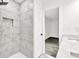 This stand-up shower with marble and natural light is located in the main bathroom at 3233 Glynn Mill Dr, Snellville, GA 30039