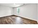 An empty bedroom with wood-look flooring and white walls receives lots of light at 3233 Glynn Mill Dr, Snellville, GA 30039