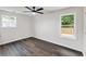 Bright bedroom with sleek ceiling fan, laminate flooring, and windows offering natural light at 3233 Glynn Mill Dr, Snellville, GA 30039