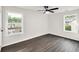 This bedroom has two windows with a ceiling fan and laminate flooring at 3233 Glynn Mill Dr, Snellville, GA 30039