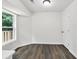 An area with a large window with wood-look flooring and freshly painted white walls at 3233 Glynn Mill Dr, Snellville, GA 30039