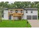 Charming two-story home featuring a spacious front yard, upper balcony, and a two car garage at 3233 Glynn Mill Dr, Snellville, GA 30039