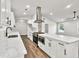 Modern kitchen with white cabinets, quartz countertops, stainless steel appliances and hardwood floors at 3233 Glynn Mill Dr, Snellville, GA 30039