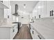 Bright kitchen features white cabinets, marble backsplash, stainless steel appliances, and wood-look floors at 3233 Glynn Mill Dr, Snellville, GA 30039