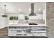 Bright kitchen island features white cabinets, marble countertop, and stainless steel appliances at 3233 Glynn Mill Dr, Snellville, GA 30039