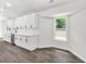 Bright kitchen features white cabinets, marble backsplash, stainless steel appliances, and wood-look floors at 3233 Glynn Mill Dr, Snellville, GA 30039