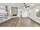 Stylish living area features a stone fireplace, modern ceiling fan, and hardwood flooring at 3233 Glynn Mill Dr, Snellville, GA 30039
