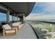 A serene balcony with cozy seating and city views through a glass barrier at 3344 Peachtree Ne Rd # 3405, Atlanta, GA 30326