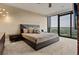 Serene bedroom with a large window showcasing a green view, plush carpet, and a contemporary style platform bed at 3344 Peachtree Ne Rd # 3405, Atlanta, GA 30326