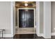 Elegant entryway with dark wood double doors, decorative lighting, and travertine flooring leading into the home at 3344 Peachtree Ne Rd # 3405, Atlanta, GA 30326