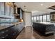 Modern kitchen featuring dark cabinetry, stainless steel appliances, and an island with stone countertop and unique tile accents at 3344 Peachtree Ne Rd # 3405, Atlanta, GA 30326